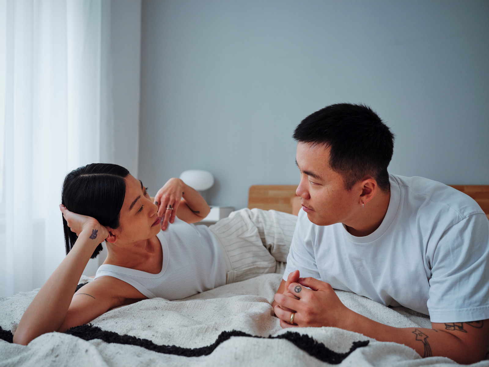 Couple having a serious conversation in bed